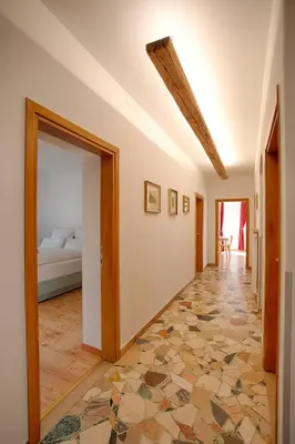a hallway with a room with a bed and a doorway at Apartment Hofgarten - Alpstay in Naturno