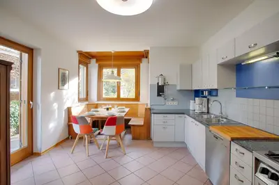 a kitchen with a table and chairs in it at Apartment Hofgarten - Alpstay in Naturno