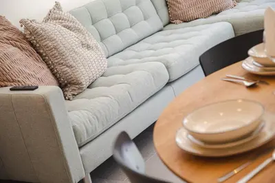 a living room with a couch and a wooden table at Apartment Lavendel - Alpstay in Naturno