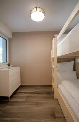 a bedroom with two bunk beds and a desk at Apartment Lavendel - Alpstay in Naturno