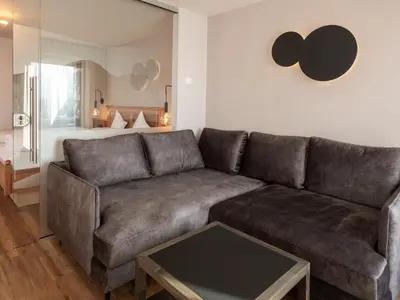a living room with a couch and a table at Hotel Bacherhof in Maranza