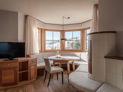 a living room with a table and a tv at Hotel Bacherhof in Maranza