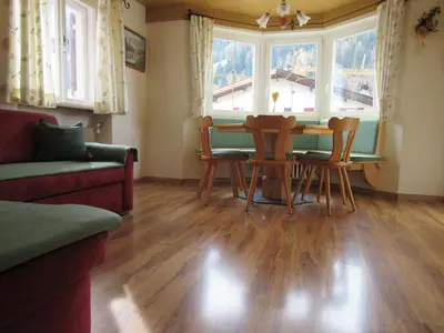 a living room with a table and chairs and a couch at Apartment Pössnecker in Selva di Val Gardena