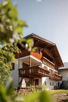a living room with a table with a book and a couch at Oberschoeberlehof in Merano
