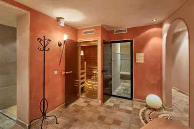 a hallway with a walk in shower and a glass door at Garni Karin in Corvara in Badia
