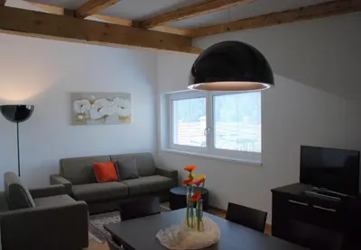 a living room with a couch and a table at Aparthotel Pichler in Colle Isarco