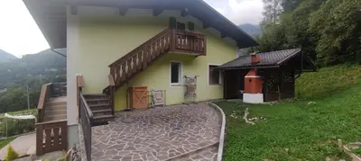 a house with a balcony on the side of it at A&J House in Canale San Bovo