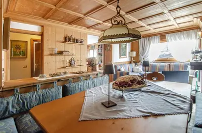 a kitchen with a table with a plate on it at Splendido appartamento a due passi dal centro con terrazza e garage in Cortina dʼAmpezzo