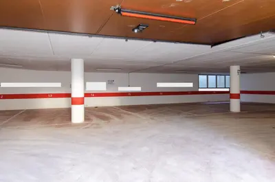 an empty room with red and white columns in a building at Splendido appartamento a due passi dal centro con terrazza e garage in Cortina dʼAmpezzo