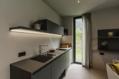 a kitchen with a sink and a counter with a window at Agriturismo Insolito in Terlano
