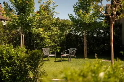two chairs sitting in the grass in a yard at Agriturismo Insolito in Terlano