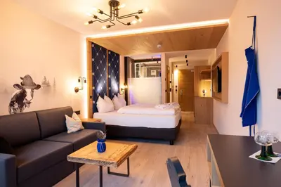 a bathroom with a sink and a shower and a bed at Luis & die Buabm - Gasthof Jenesien in San Genesio Atesino