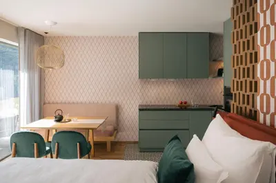 a bedroom with a bed and a table and a kitchen at ANTON Nature Hideaway in Naz-Sciaves