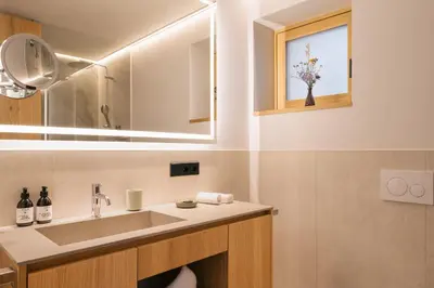 a bathroom with a sink and a mirror at ANTON Nature Hideaway in Naz-Sciaves