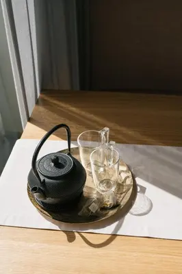 a plate with glasses and a black phone on a table at ANTON Nature Hideaway in Naz-Sciaves