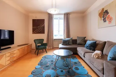 a living room with a couch and a tv at Apartment Perwanger in Appiano sulla Strada del Vino