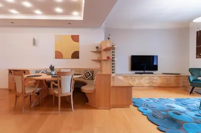 a living room with a dining table and a tv at Apartment Perwanger in Appiano sulla Strada del Vino