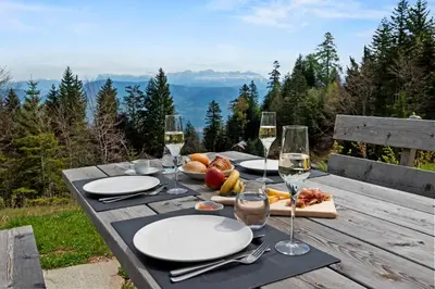 a house on a hill with mountains in the background at NEW OPENING 
