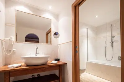 a bathroom with a sink and a shower at Hotel Sonnenhof in Castelrotto