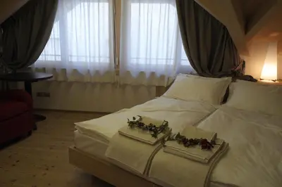 a bedroom with a bed with two trays with flowers on it at Agriturismo Casa Preti in Revò