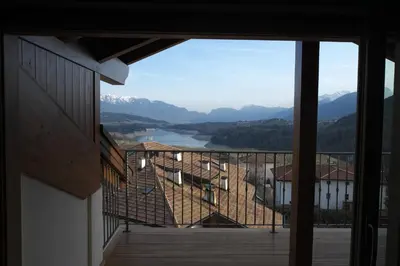 a balcony with a view of a lake and mountains at Agriturismo Casa Preti in Revò