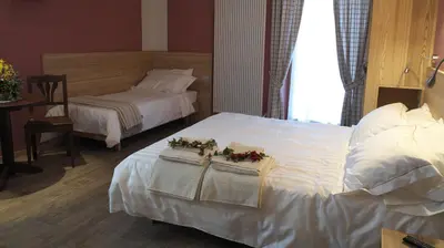 a hotel room with two beds with flowers on them at Agriturismo Casa Preti in Revò