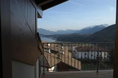 a balcony with a view of a river and mountains at Agriturismo Casa Preti in Revò