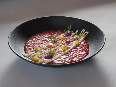 a bowl of sauce with pasta and vegetables in it at Hotel Ostaria Posta in San Martino in Badia