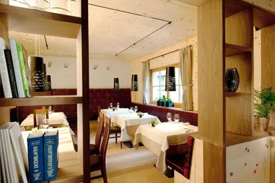 a dining room with white tables and chairs at Hotel Ostaria Posta in San Martino in Badia