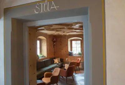 a living room with a couch and chairs at Hotel Ostaria Posta in San Martino in Badia