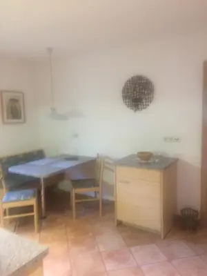 a dining room with a table and chairs in a room at Apartments Dilln Gütl in Tires