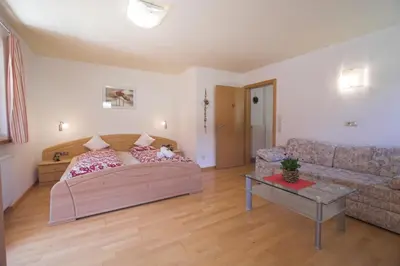 a living room with a bed and a couch at Apartments Dilln Gütl in Tires