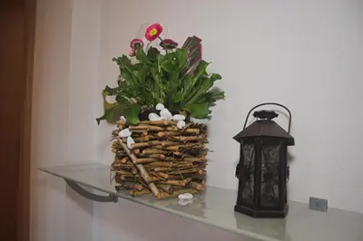 a glass shelf with a flower arrangement and a lantern at Apartments Dilln Gütl in Tires