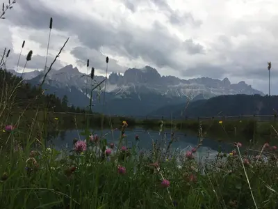 a body of water with mountains in the background at Apartments Dilln Gütl in Tires