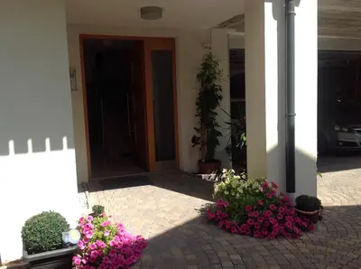 a front door of a house with pink flowers at Apartment Welscher in Nova Levante