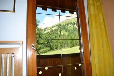 a window with a view of a mountain at Villa Tamion in Vigo di Fassa
