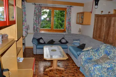 a living room with a couch and a table at Villa Tamion in Vigo di Fassa