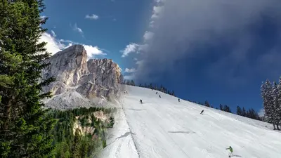 a group of people skiing down a snow covered mountain at Pension Peintner in Gais