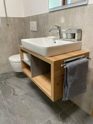 a bathroom with a sink and a toilet at Stroblhof in Vipiteno