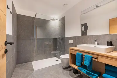 a bathroom with a sink and a shower at Linhea Apartments in Fiè