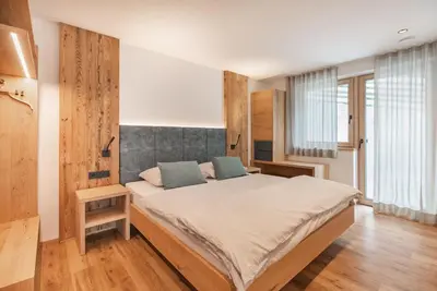 a bedroom with a large bed in a room at Linhea Apartments in Fiè