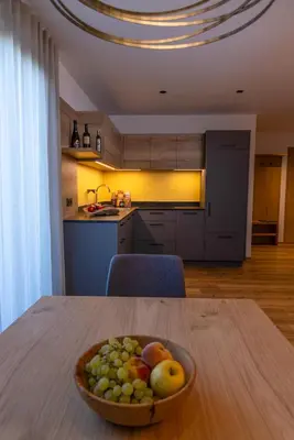 a bowl of fruit on a table in a kitchen at Linhea Apartments in Fiè
