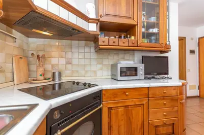 a kitchen with a stove and a microwave at Casa Alice in Falcade