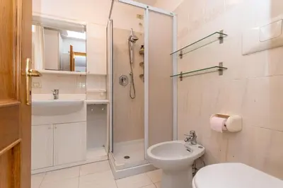 a bathroom with a shower and a toilet and a sink at Casa Alice in Falcade