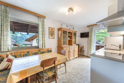 a kitchen with a table and a counter top at Apartments Martina in Selva