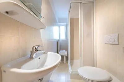 a bathroom with a sink and a toilet and a shower at Apartments Martina in Selva