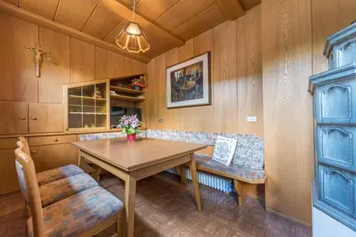 a dining room with a table and a bench at Apartments Martina in Selva