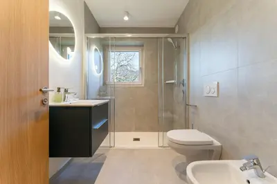 a bathroom with a shower and a toilet and a sink at Apartments Villa Julia in Lana