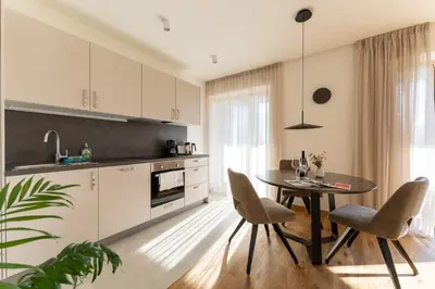 a kitchen with a table and chairs in a room at Apartments Villa Julia in Lana
