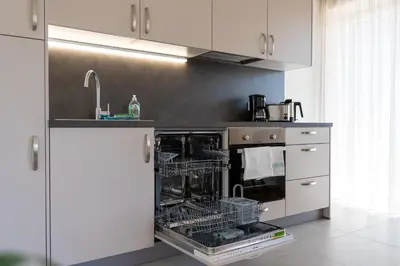 a kitchen with an oven with dishes in it at Apartments Villa Julia in Lana